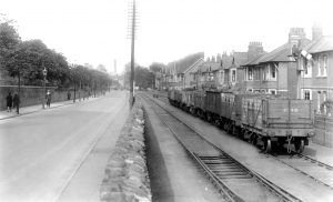  1. Cardiff Rd Sidings 1930 The railway storage sidings on Cardiff Road outside the Royal Gwent Hospital in the summer of 1930. Officially known as 'Pitwood Sidings', the lines originally formed part of the early tramroad route along Cardiff Road to the wharves on the River Usk via George Street and Kingsway. From 1852 this route through the streets of Newport was developed by the Monmouthshire Railway & Canal Company into a passenger service from the Western Valleys that headed through Salutation Junction and George Street, terminating at Dock Street Station. Through running of rail traffic from Courtybella Junction ceased in 1907, and all traffic used the alternative route via the 'Neutral Mile' section through Pillgwenlly. Although out of use from 1907 the GWR maintained its right of way along the original route until the 1920's by the annual passage of a locomotive running light on Good Fridays. Newport Reference Library