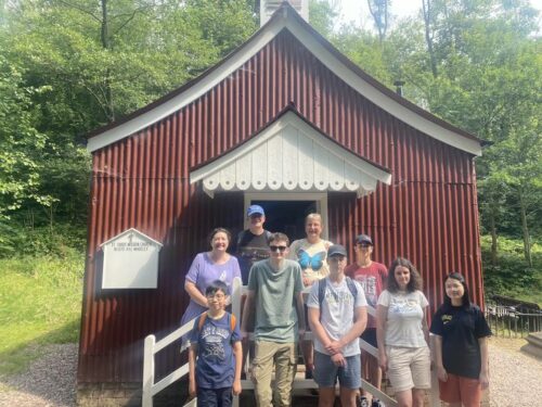 Group of Young People outside a tin hut chapel