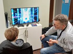 Steve and a young person on a games console